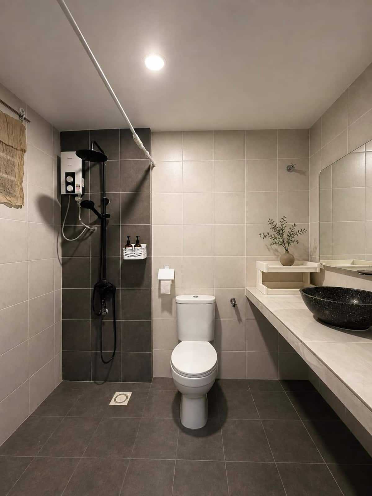 Bathroom with a shower, wall-mounted water heater and a vessel basin