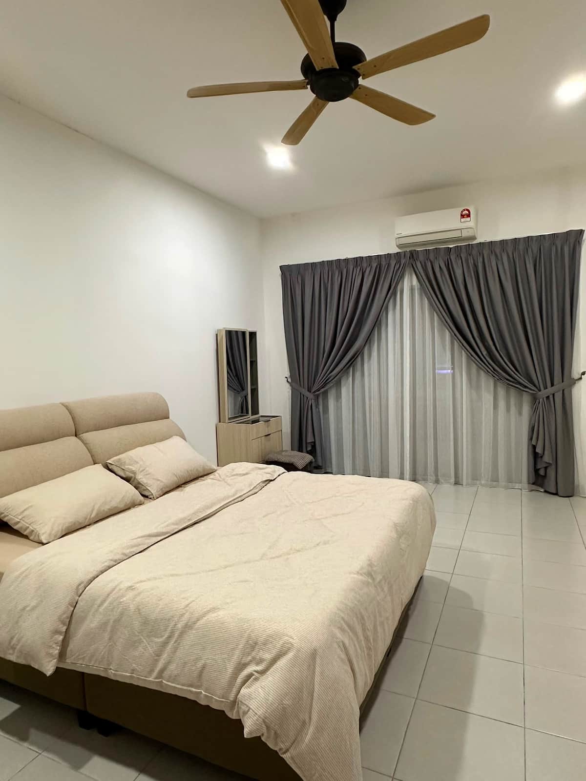 Bedroom with a padded headboard, ceiling fan and built-in wardrobe